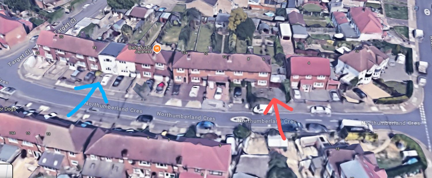 Northumberland Crescent from the air. The red arrow marks the gap at the end of the terrace where the garage sits. The blue arrow marks the white flat roofed building that breaks the otherwise consistent run of two storey houses with pitched roofs and long rear gardens.