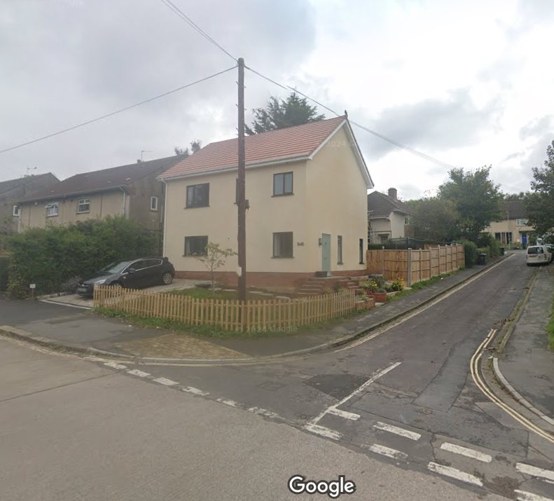 The house built opposite under the earlier permission. It copies the render, the roof pitch and the window pattern of the older houses either side of it, which is exactly why the council accepted it.